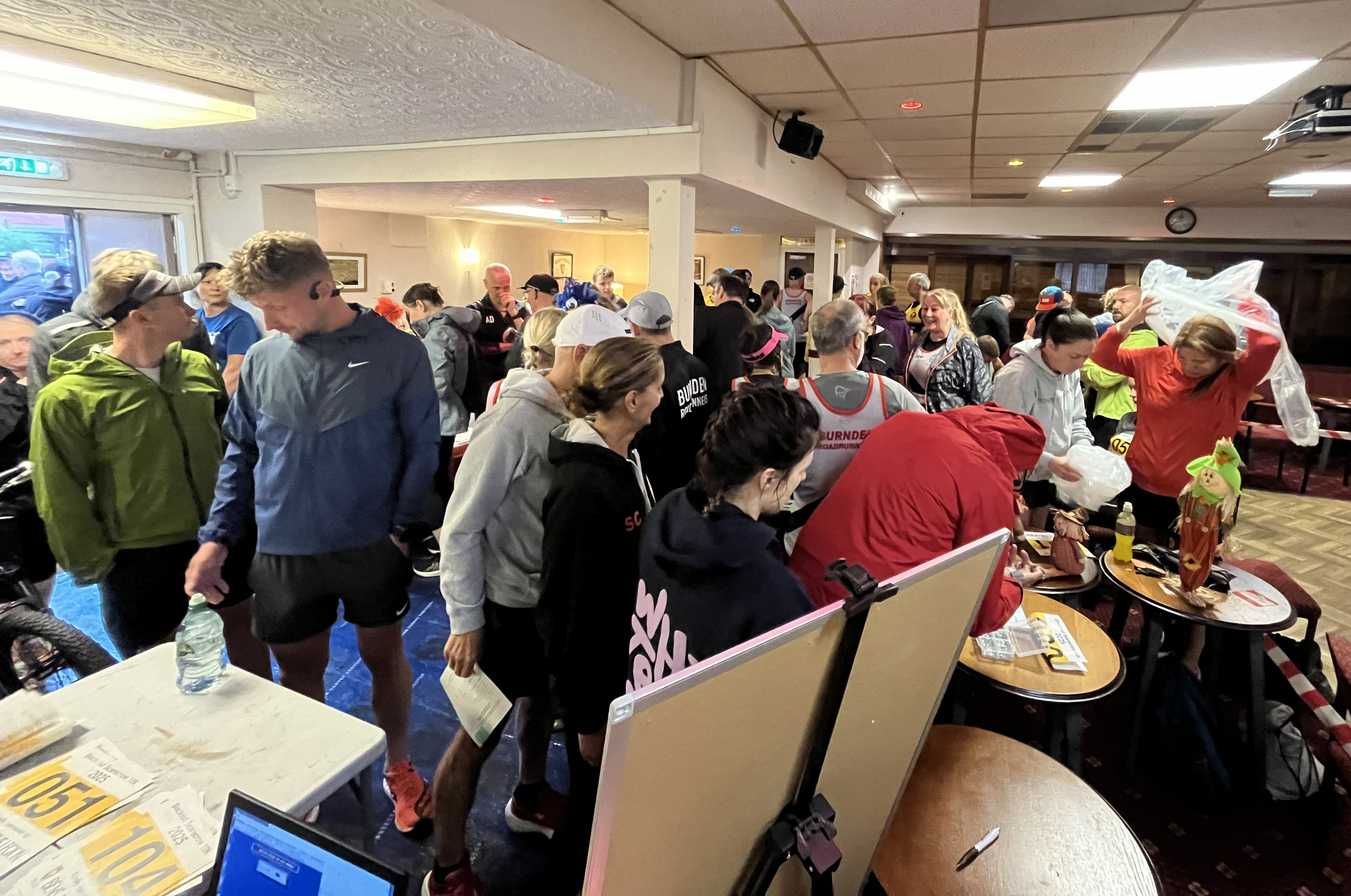 Registration desk with volunteers issuing race numbers