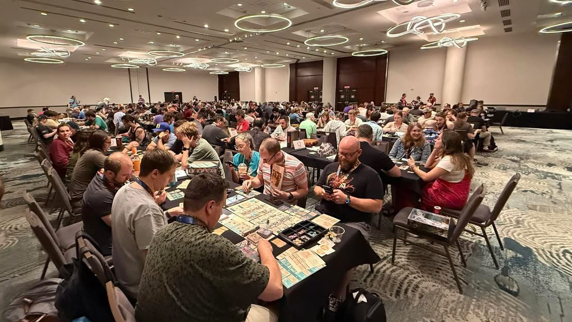 Board gamers gathered at a convention playing tabletop games